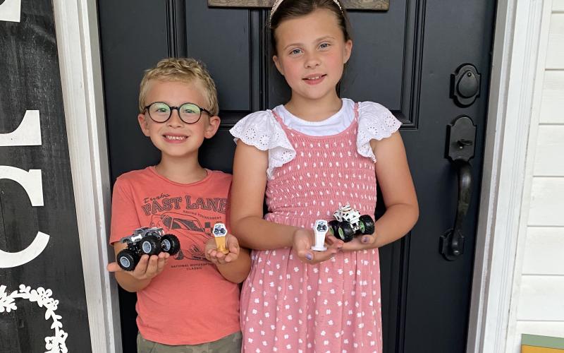 Lincoln Gaddy shows off ‘Bone Snake,’ his custom diecast monster truck, and the championship trophy the truck won in OurTime4Adventures’ Kids Custom Easter tournament. Harper, his sister, previously defeated him in a 1-on-1 race on her birthday. (COURTESY)
