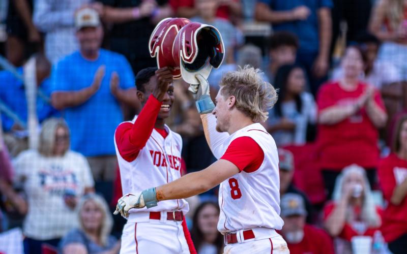 Lafayette second baseman Dawson Cannon (8) celebrates with outfielder Tywan Williamson following his solo home run against Aucilla Christian during Game 2 of the Region 3-R semifinals on Tuesday. (JACK HOWDESHELL/Lake City Reporter)