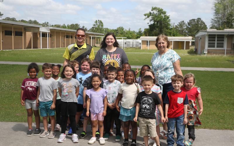 Summers Elementary School VPK paraprofessional Kelsie Rodriguez (back middle) has been named a finalist for the state’s School-Related Employee of the Year award. Rodriguez is pictured with her VPK students as well as Summers Principal Robert Cooper and VPK teacher Karen McDonald. (MORGAN MCMULLEN/Lake City Reporter)