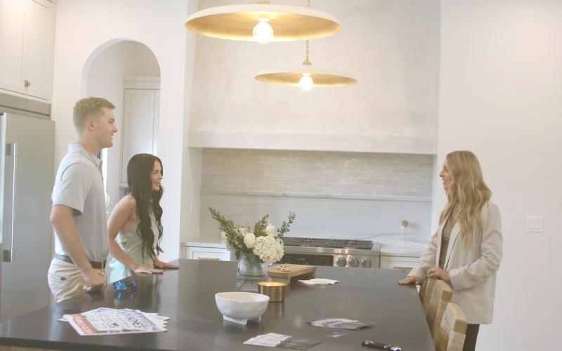Rylee and Adrianna McKenzie talk with Noelle Royster (right), who was helping to show the home near Lake Jeffery for IC Construction during the 2024 Parade of Homes. (FILE)