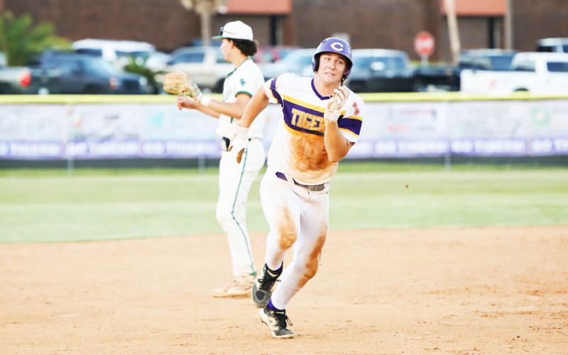Columbia’s Ayden Phillips races to third base during Friday’s win over Flagler Palm Coast. (BRENT KUYKENDALL/Lake City Reporter)