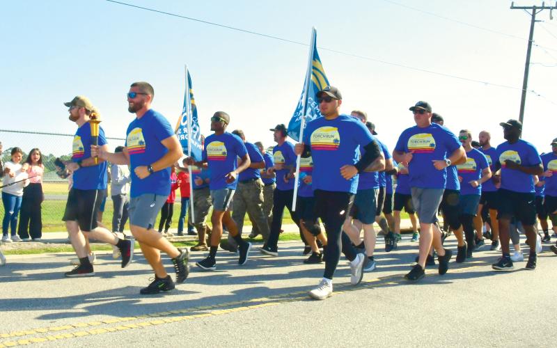 Law enforcement officials take part in Friday’s annual Law Enforcement Torch Run. (ROB WOLFE/Lake City Reporter)