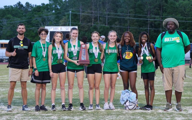 The Suwannee girls track and field team placed second at the District 2-2A meet on Tuesday. Pictured are coach Brian Bullock (from left), Montana Lewis, Ryleigh Hermanson, Arwen Haley, Olivia Hermanson, Madison Chamberlain, Jo’Keria McMullen, Kennedy Jennings and coach Twon Williams. (COURTESY)