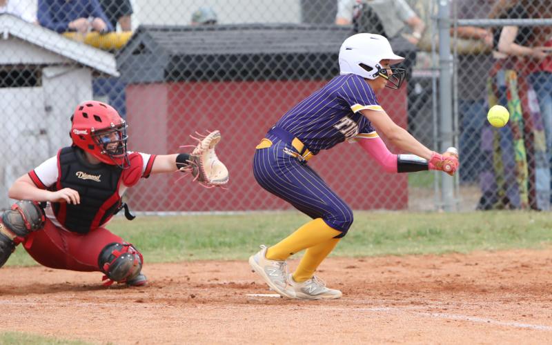 Columbia shortstop Lillyenne Mayhew tries to get down a bunt against Baker County in the District 3-4 championship on Thursday. (BRENT KUYKENDALL/Lake City Reporter)