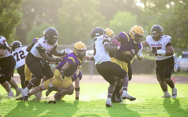 Columbia defensive tackle Jaylen Underwood (8) delivers a hit to Fort White running back Elijah Gardner during the teams’ spring game on May 17. (BRENT KUYKENDALL/Lake City Reporter)