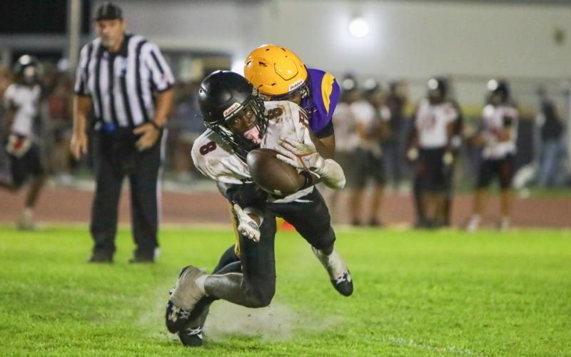 Fort White's Jayden Jackson can't hold on to a catch as he's hit by Columbia defensive back Von Lane during Saturday's spring game. (BRENT KUYKENDALL/Lake City Reporter)