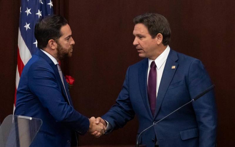 Florida Governor Ron DeSantis (right) shakes hands with Florida House Speaker Daniel Perez after delivering his State of the State during the first day of the legislative session at the Florida State Capitol on March 4 in Tallahassee. (MATIAS J. OCNER/Miami Herald/TNS)
