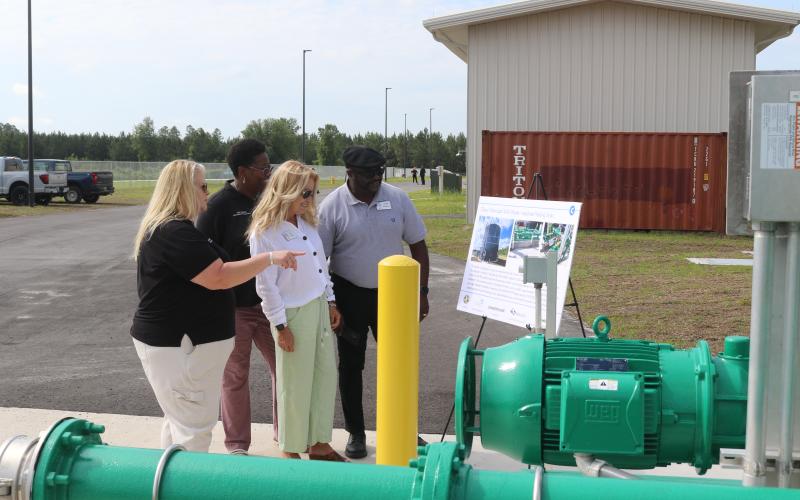 Columbia County Economic Development Director Jennifer Daniels (from left) tells Van Brown and Small Business Administration representatives Tina Davis and Donnie Anderson about tanks and lines at the North Florida Mega Industrial Park wastewater plant during a tour Thursday morning. (TONY BRITT/Lake City Reporter)