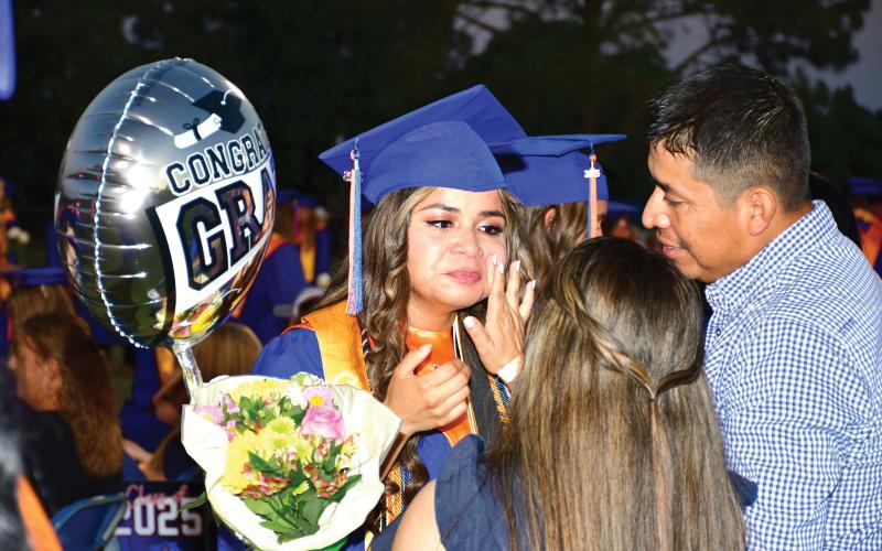 Tears are wiped away from Branford graduate Ashley Morales’ face during an emotional moment with loved ones Friday night during Branford’s commencement. BHS seniors take the class flower — a white rose this year — to parents and family members during the ceremony. (ROB WOLFE/Lake City Reporter)
