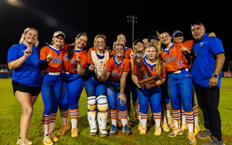 Branford's softball team poses with the District 6-R trophy after defeating Fort White 3-1 on Thursday. (JACK HOWDESHELL/Lake City Reporter)