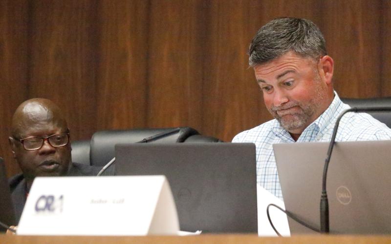 Live Oak Community Redevelopment Agency Chairman Matt Campbell (right) grimaces as he looks over petitions submitted by Board Member Tommie Jefferson (left) in support of a privacy fence around J&amp;W Auto Sales. Jefferson, who collected the petitions on city letterhead, also said during Tuesday’s CRA meeting that he wasn’t seeking any CRA approval. Campbell then asked why was it being discussed at that board’s meeting. (JAMIE WACHTER/Lake City Reporter)