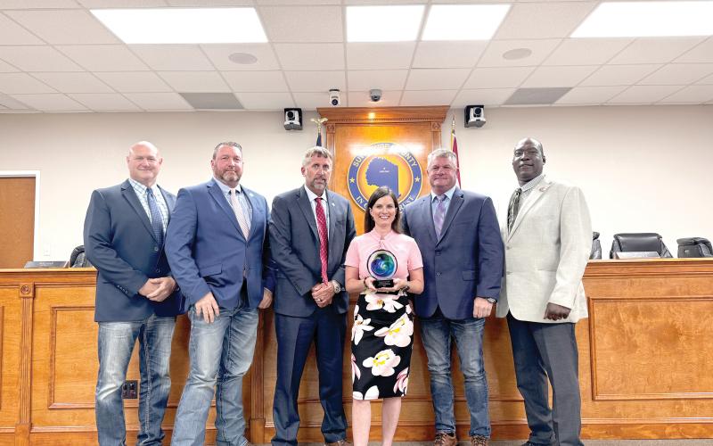 Suwannee County Economic Development Coordinator Charissa Setzer holds the ‘Innovation in Marketing’ award the county’s ‘We are Suwannee’ campaign earned at the Florida Economic Development Council conference last week. She is joined by commissioners Don Hale (From left), Leo Mobley, Travis Land, Franklin White and Maurice Perkins. (JAMIE WACHTER/Lake City Reporter)
