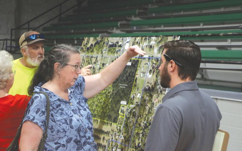 Maureen Bentley (left) speaks with Cory Chandler, an engineer with Landis Evans + Partners during the April 30 presentation about the mixed-use development proposed for Live Oak across from the Suwannee County Coliseum. (MORGAN MCMULLEN/Lake City Reporter)
