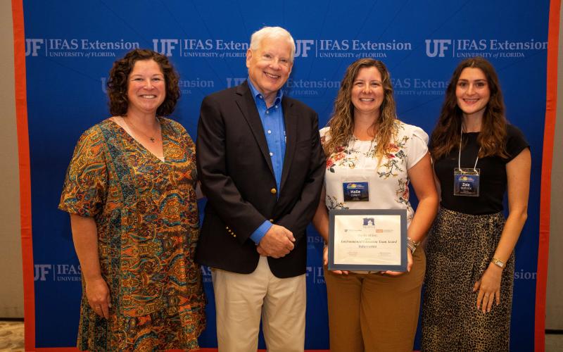 Columbia County UF/IFAS Extension Agent Halie Corbitt (second from right) holds the Environmental Education team award at the 2025 Extension Professional Associations of Florida Symposium. The award went to the Columbia County team, including Heather Futch (left) and Zoie Whitlock (right) as well as Paulette Tomlinson, Erin Harlow, Kalie Picklo, Julia Fulton and the Columbia Master Gardener volunteers. (COURTESY)