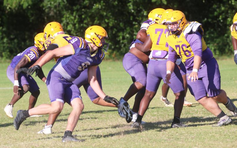 Columbia defensive end Kyten Davis (left) rushes into the backfield as center Zackery Grimes turns to block during Monday's practice. (JORDAN KROEGER/Lake City Reporter)