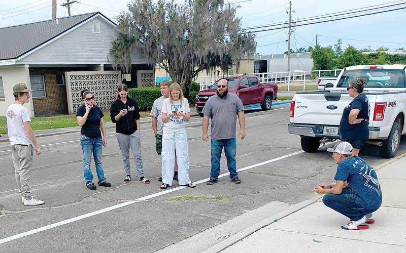 Friends and family of William Powell Jr., the 18-year-old shot and killed in White Springs on Saturday, which includes Hunter Daniels, Stormy Smith, Jake Cribbs, Joedy Powell, Briana Powell, Jamie Blankenship and Sherry Blankenship wait for the press briefing to begin Tuesday morning outside of the Hamilton County Courthouse. (JASON WILKINSON/Lake City Reporter)