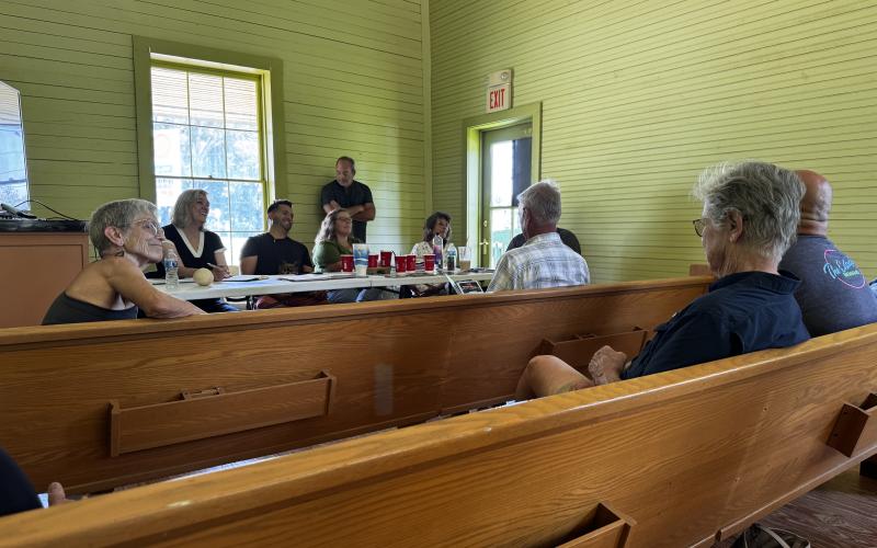 Main Street America senior program officer Lisa Thompson (second from left) and Main Street of Fort White board members listen to community residents during a public roundtable discussion Thursday at the historic train depot in Mayor’s Park. The discussion centered around the community’s vision for the town. (JAMIE WACHTER/Lake City Reporter)