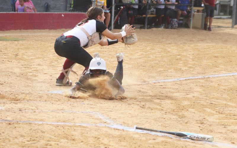 West Nassau catcher Vida Kersey is called for obstruction as Suwannee runner TT Hill slides into home plate for the game-winning run in the top of the eighth inning of Friday’s Region 1-3A quarterfinal. (MORGAN MCMULLEN/Lake City Reporter)
