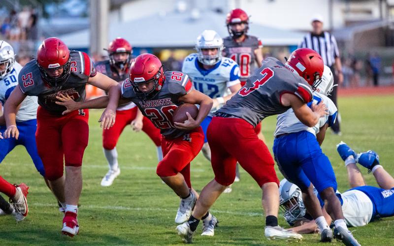 Lafayette running back Alex Townsend (20) runs in for a touchdown behind the block of Dayne McCray (3) during the Hornets’ half of action against Interlachen during Tuesday’s spring jamboree. (JACK HOWDESHELL/Lake City Reporter)