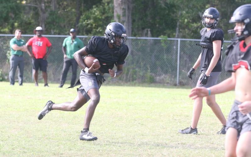 Fort White quarterback Jayden Jackson takes off from the pocket during Thursday’s spring practice. (MORGAN MCMULLEN/Lake City Reporter)