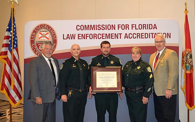 The Columbia County Sheriff’s Office received its reaccreditation status June 19 at the FLA-PAC Conference in Orlando. Receiving the recognition for the CCSO were Chief Deputy Katina Dicks (second from left), Sgt. James Cason (middle) and Sgt. Amy Geier (second from right). (COURTESY)