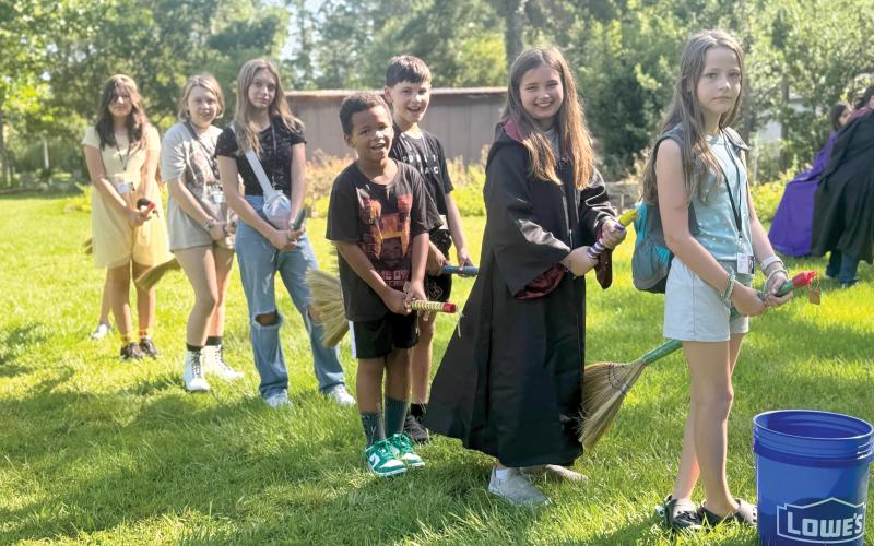 4-H campers Lumen Jimenez (from let), Amelia Mears, Kenleigh Markham, Carter Jordan, Emerson Coleman, Penelope Regar and Heaven Marton have broom practice in preparation for playing Quadball. (PHOTOS COURTESY UF/IFAS COLUMBIA COUNTY EXTENSION)