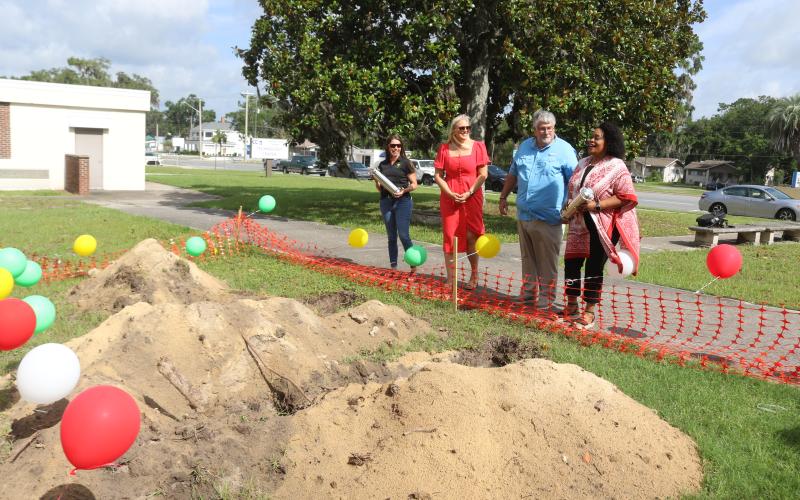 Five Points Elementary School Principal Brandi Keen (left) and Melrose Park Elementary School Principal Makeba Murphy (right) hold the time capsules prior to their burial as Columbia County Public Schools Foundation Director Dianna Swisher and Superintendent Keith Couey look on. (TONY BRITT/Lake City Reporter)