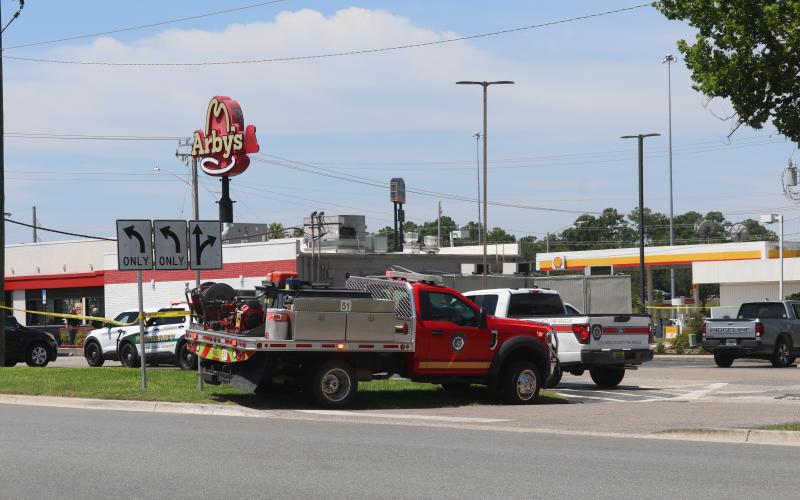 Columbia County Sheriff's Office and Columbia County Fire Rescue vehicles line the taped-off parking lot at Arby's on Thursday following a shooting at the restaurant. (JAMIE WACHTER/Lake City Reporter)