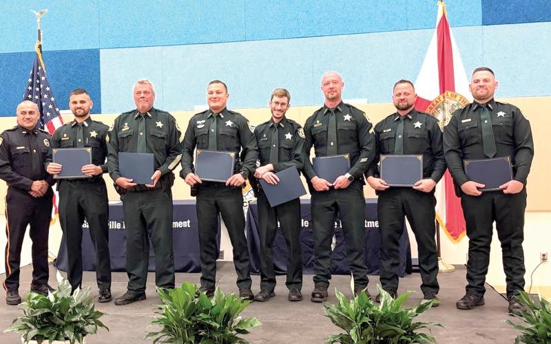 The Gainesville Police Department honored 12 Columbia County deputies and six communication officers on Friday with Police Service Awards for their help in capturing a fleeing murder suspect last year. (COURTESY)
