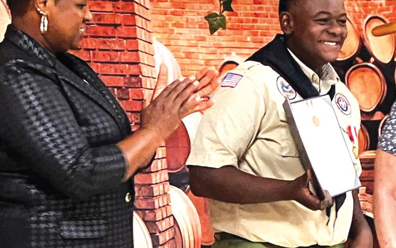 Josiah Jackson ‘JJ’ Kolwyck (right) receives a national Boy Scouts of America Award for saving a motorist during Hurricane Debby last summer. (COURTESY)