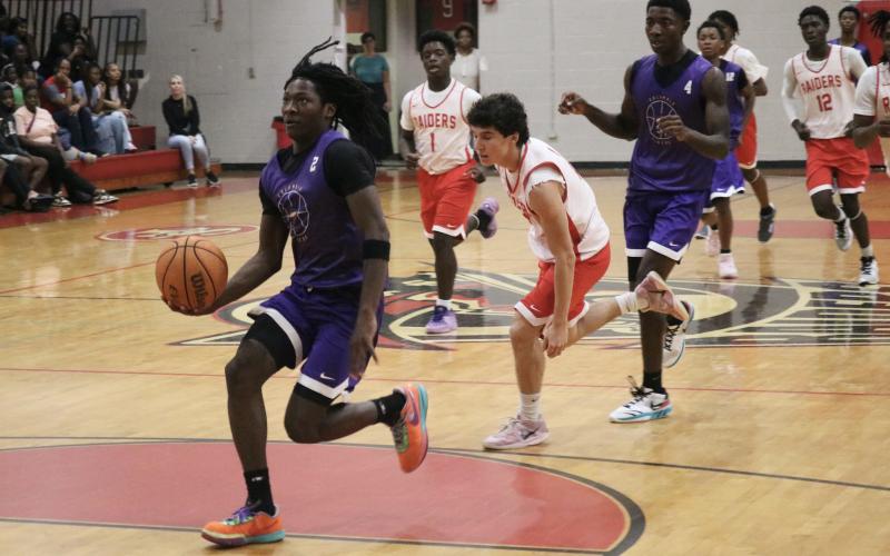 Columbia guard Kadrian Wilson drives to the basket on a fast break against Santa Fe on Tuesday. (JORDAN KROEGER/Lake City Reporter)