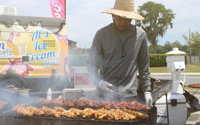 Auman Tamesis of Maya’s Merienda tends a variety of Filipino street food on the grill during the inaugural Multicultural Fiesta last year. The City of Lake City’s second Multicultural Day celebration is set for Saturday. (FILE)
