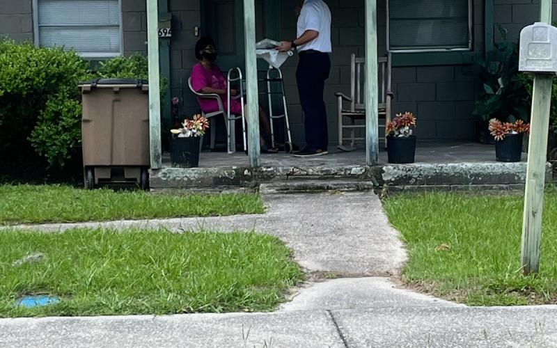 Lake City Assistant Fire Chief Ret Tompkins stops at a residence Tuesday to help install smoke detectors and provide disaster preparedness information. (COURTESY LAKE CITY FIRE DEPARTMENT)