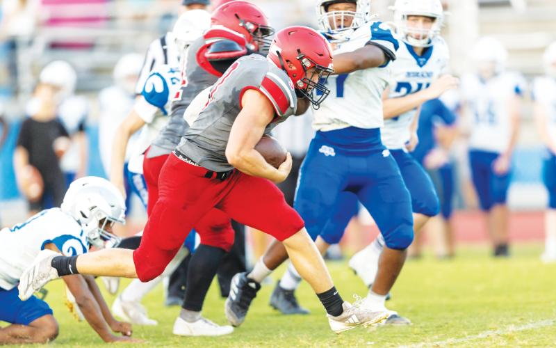 Lafayette running back Dayne McCray gains a chunk of yardage against Keystone Heights during their spring jamboree on May 20. (JACK HOWDESHELL/Lake City Reporter)