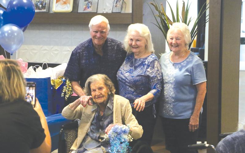 Ed Higgins (back row from left), Andra Higgins and Sharron O’Quinn join with Mary Higgins for her 106th birthday party. (MORGAN MCMULLEN/Lake City Reporter)