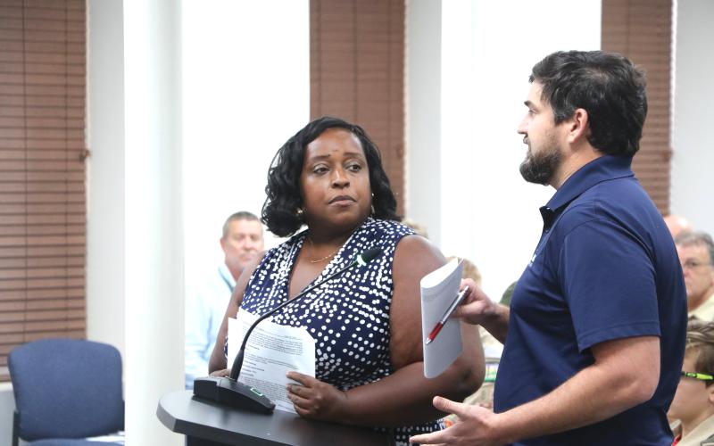Shannon Williams (left) and Michael Klink update the Lake City Council on a Hazard Mitigation Grant meant for restoration at Gwen Lake during Monday’s meeting. (MORGAN MCMULLEN/Lake City Reporter)