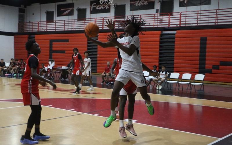 Fort White guard Tylan James goes for a reverse layup in Fort White’s summer league opener Thursday against Williston. (MORGAN MCMULLEN/Lake City Reporter)