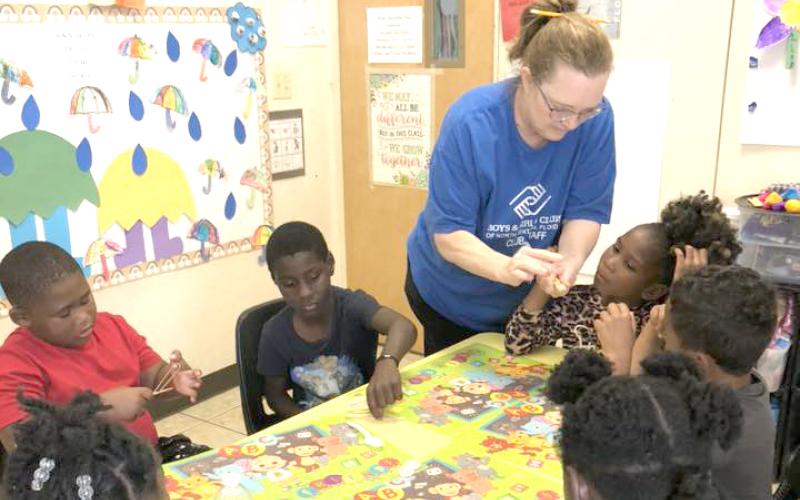 Students at the Boys and Girls Club-Mayo Unit work on making catapults during an after-school program lesson this spring. (COURTESY)