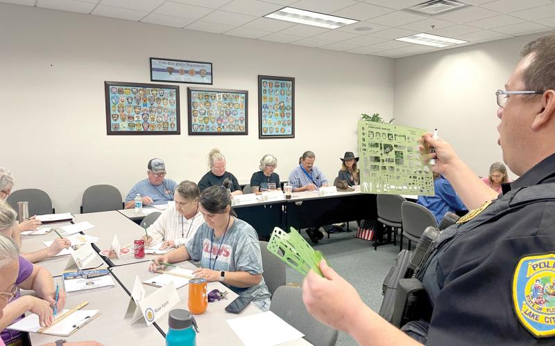 Sgt. Mike Lee with the Lake City Police Department shows members of a previous Citizen’s Police Academy the techniques used in investigating a traffic accident. (COURTESY)