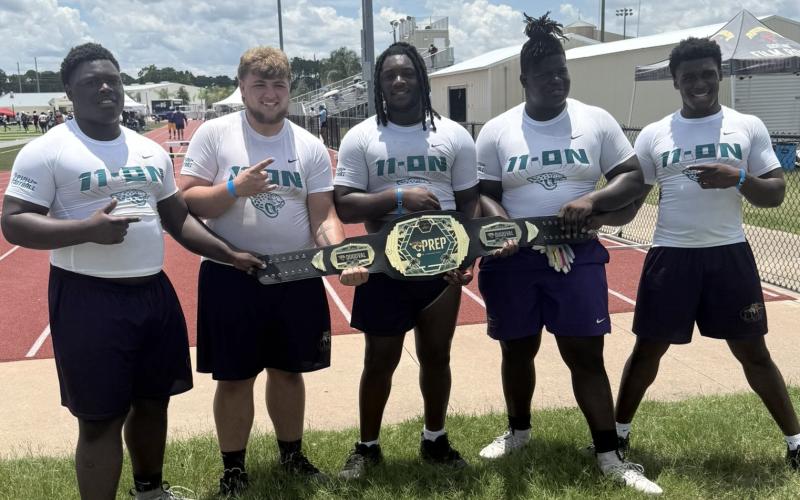 Columbia defensive lineman Jaden McCray (from left), offensive lineman Zackery Grimes, defensive lineman Jaylen Underwood, offensive lineman De’Manuel Jones and fullback Josiah Rossin celebrate with their championship belt after winning the linemen challenge at the Jaguars 11-ON on Thursday. (COURTESY)