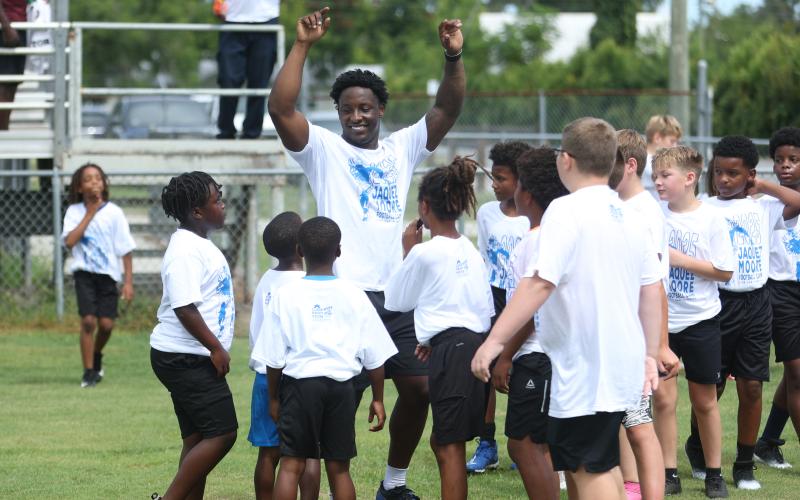 Jaquez Moore gathers campers together during his football camp on Saturday. (PAUL BUCHANAN/Lake City Reporter)