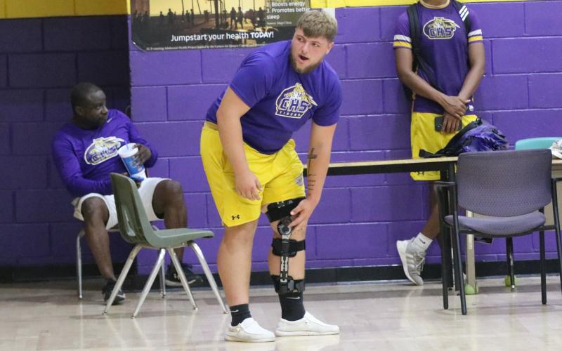 Columbia center Zackery Grimes watches practice inside the CHS gym on Monday after he recovers from tears to his ACL, MCL and meniscus in his knee. (JORDAN KROEGER/Lake City Reporter)
