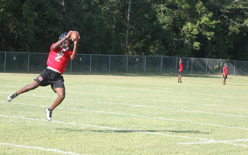 Fort White running back Elijah Gardner leaps to make a catch on a crossing route during Monday’s practice. (MORGAN MCMULLEN/Lake City Reporter)