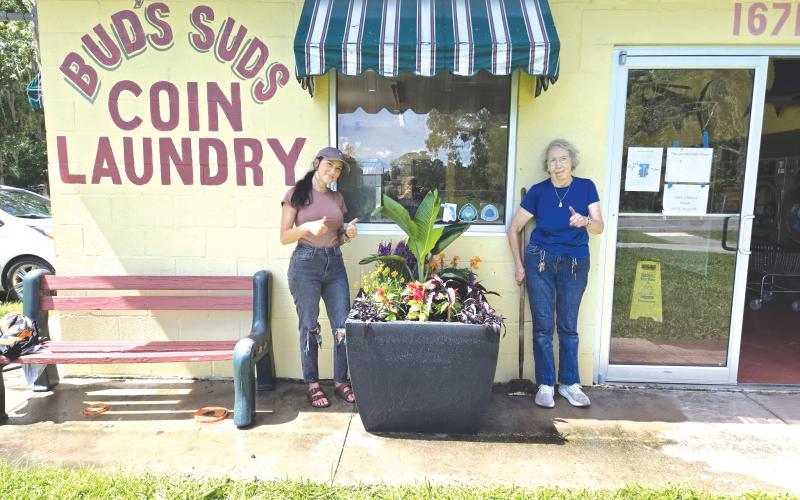 Hamilton County Director of Tourism Mia Hunter Mauldin (left) and Carol Stob, the owner of Bud’s Suds, pose next to a finished planter. (COURTESY)