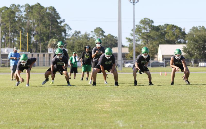 Suwannee quarterback Thomas Sikes gets set to take a snap behind offensive linemen Dalton Crossno (from left), Brody Bean, Blayne Crews, Reese Bronson and Colton Hagedorn during Monday's practice. (JAMIE WACHTER/Lake City Reporter)