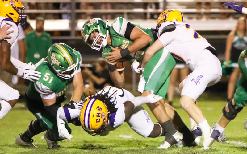 Suwannee quarterback Thomas Sikes is wrapped up by Columbia linebacker Bryson Grinstead on Friday night at Langford Stadium. (BRENT KUYKENDALL/Lake City Reporter)