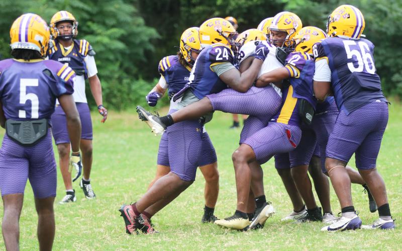 Columbia's defense swarms to tackle running back Jerome Horne during Thursday's practice. (JORDAN KROEGER/Lake City Reporter)