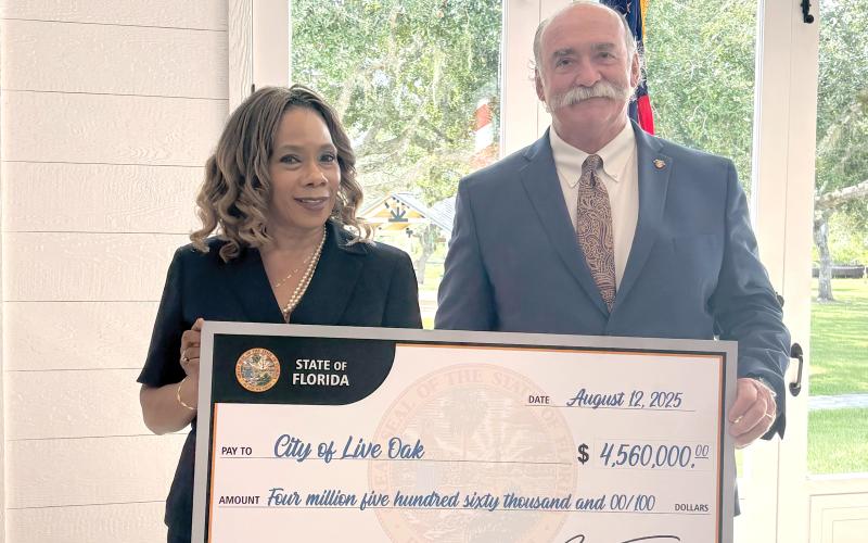 Live Oak City Manager Larry Sessions (right) and Councilwoman Vanessa Brown Robinson were in Arcadia last Thursday to receive a ceremonial $4.5 million check from the State of Florida. The funding will go toward water system improvements and home repairs for low-income families. (COURTESY)