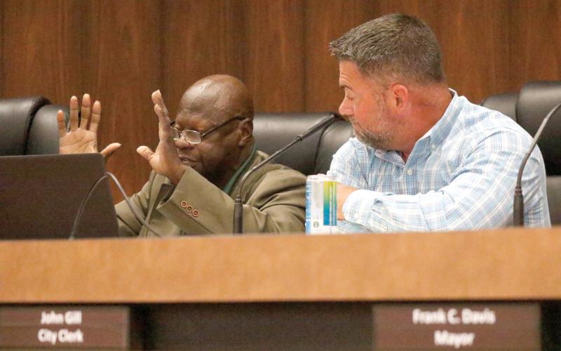 Live Oak City Council President Matt Campbell (right) looks on as County President Pro-Tem Tommie Jefferson speaks Tuesday during a budget workshop about the need for funding to pave streets in his district, including Spruce Street. (JAMIE WACHTER/Lake City Reporter)
