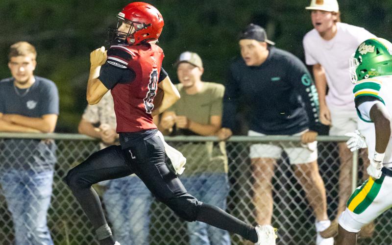 Lafayette receiver Parker Hill outruns the Suwannee defense for the game-winning touchdown on Friday. (JACK HOWDESHELL/Lake City Reporter)